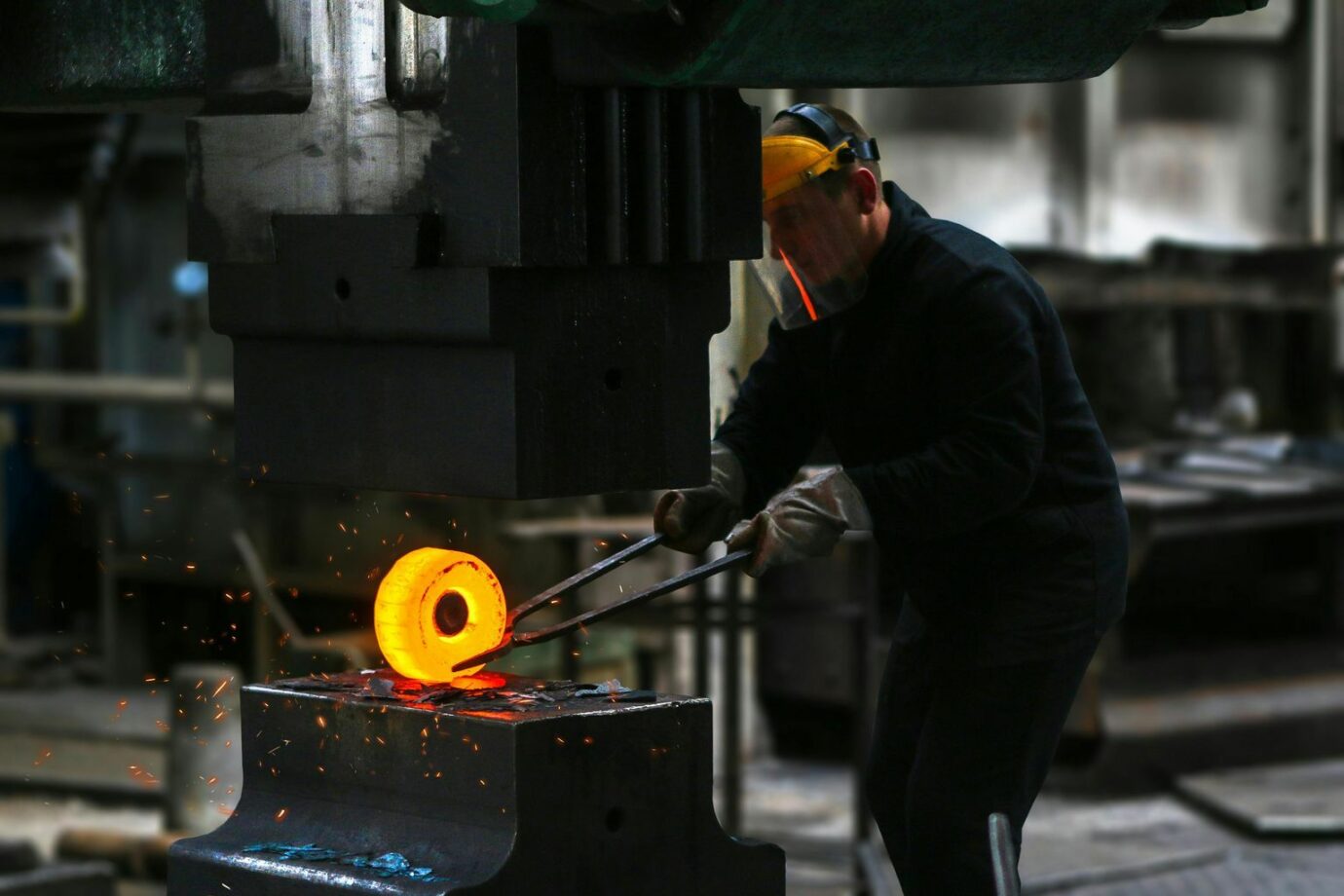 Man Lifting Hot Metal