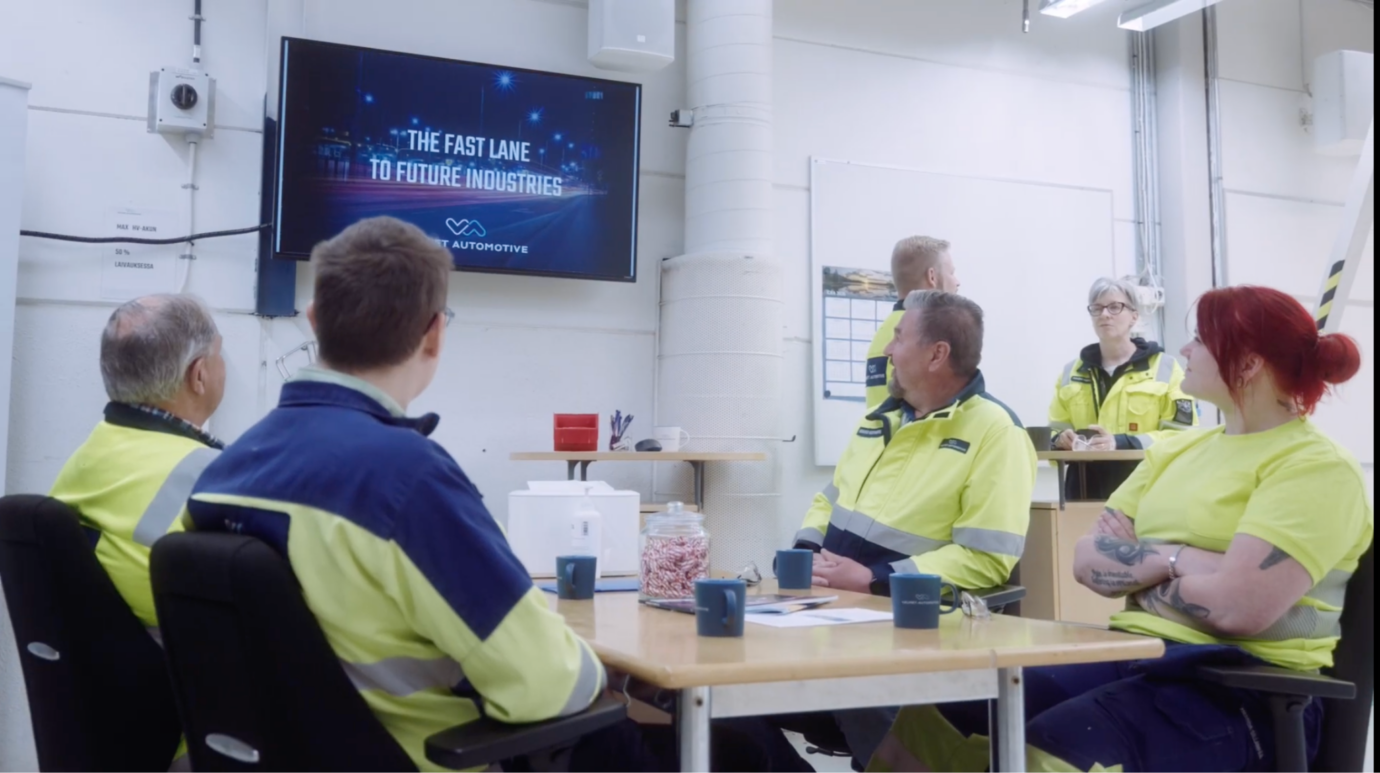 Valmet Automotive team members watching company updates on a Valotalive screen