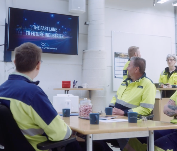 Valmet Automotive team members watching company updates on a Valotalive screen